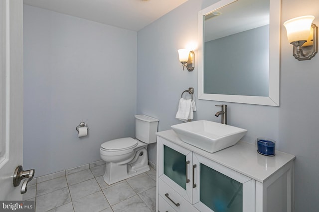 bathroom featuring tile patterned floors, vanity, and toilet