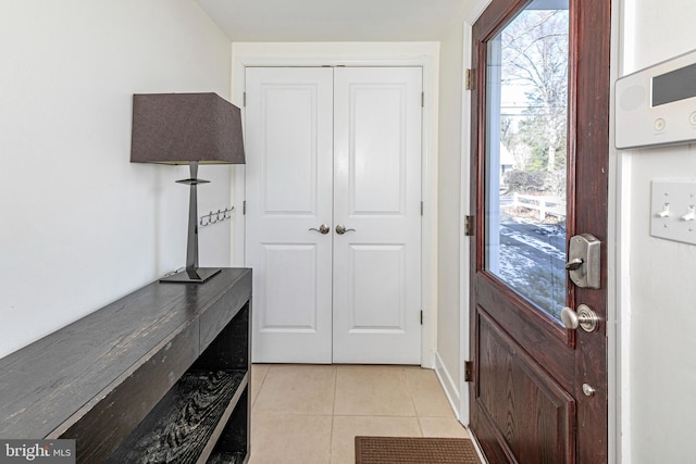 doorway with light tile patterned flooring