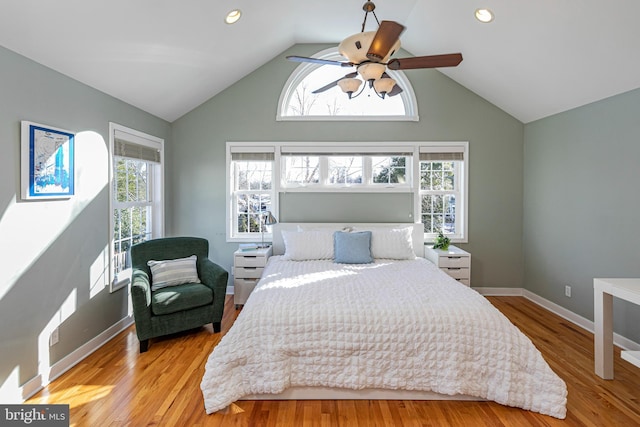 bedroom with ceiling fan, light hardwood / wood-style flooring, and lofted ceiling