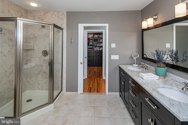 bathroom with tile patterned floors, vanity, and an enclosed shower