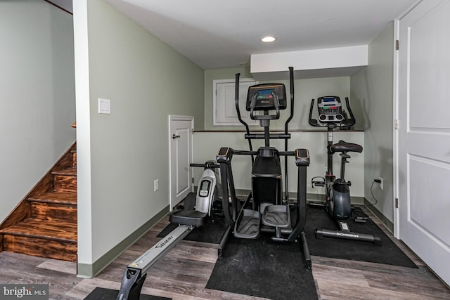 exercise room with dark wood-type flooring