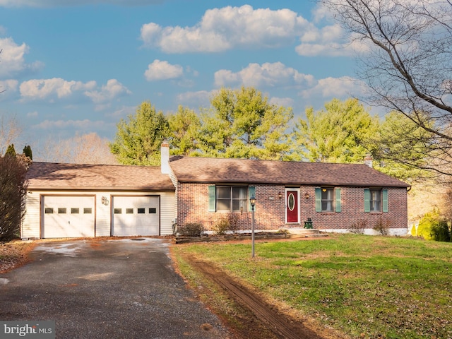 ranch-style home featuring a garage and a front yard