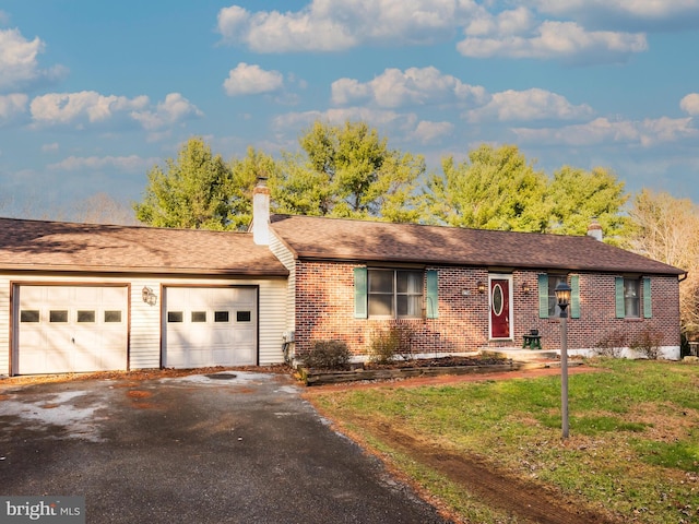 single story home with a garage and a front yard