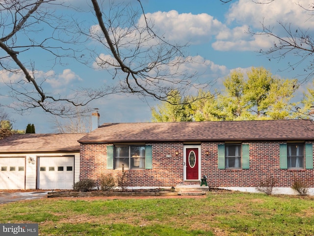 ranch-style house with a garage and a front lawn