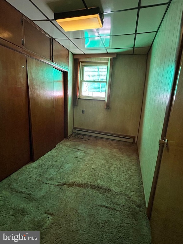 interior space with carpet flooring and a baseboard heating unit