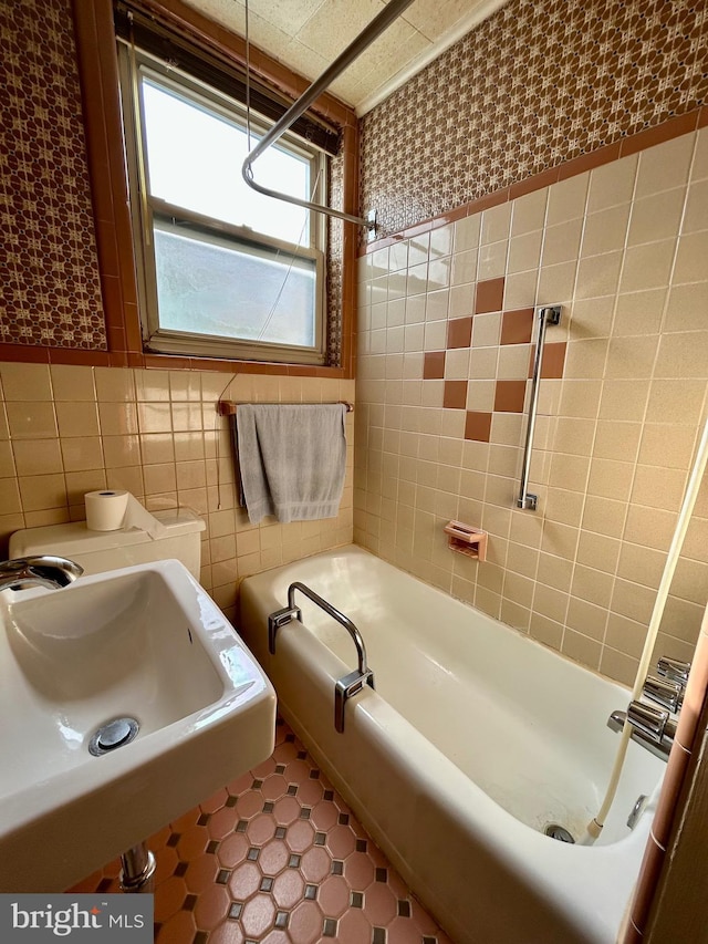 bathroom featuring tile walls and sink