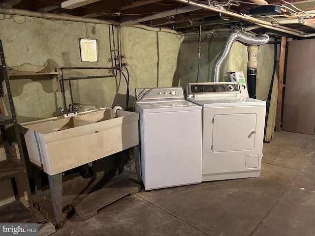 laundry area featuring washer and clothes dryer and sink