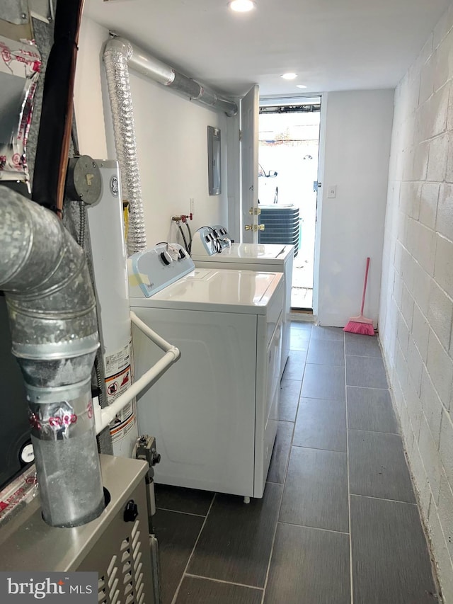 laundry area featuring washer and dryer, electric panel, and water heater