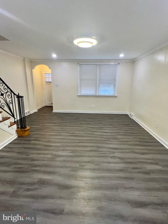 basement with crown molding and dark wood-type flooring