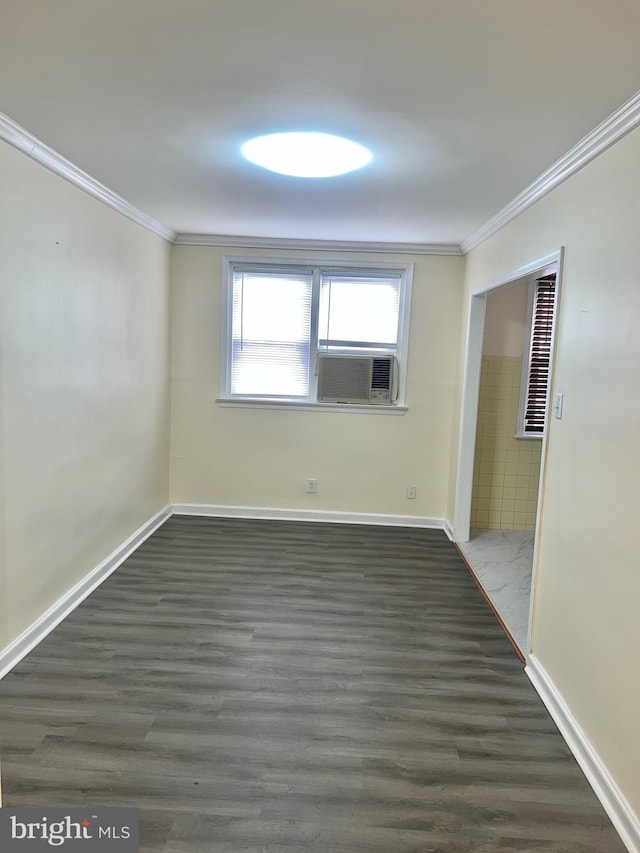 empty room featuring dark hardwood / wood-style flooring, cooling unit, and crown molding