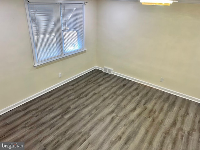 spare room featuring dark wood-type flooring