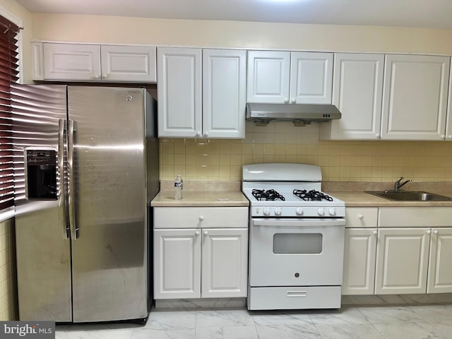 kitchen featuring white gas range, white cabinetry, sink, and stainless steel refrigerator with ice dispenser