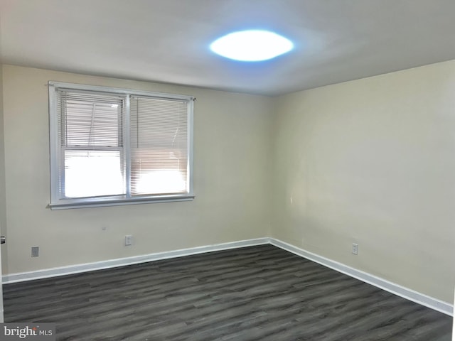 unfurnished room featuring dark hardwood / wood-style floors