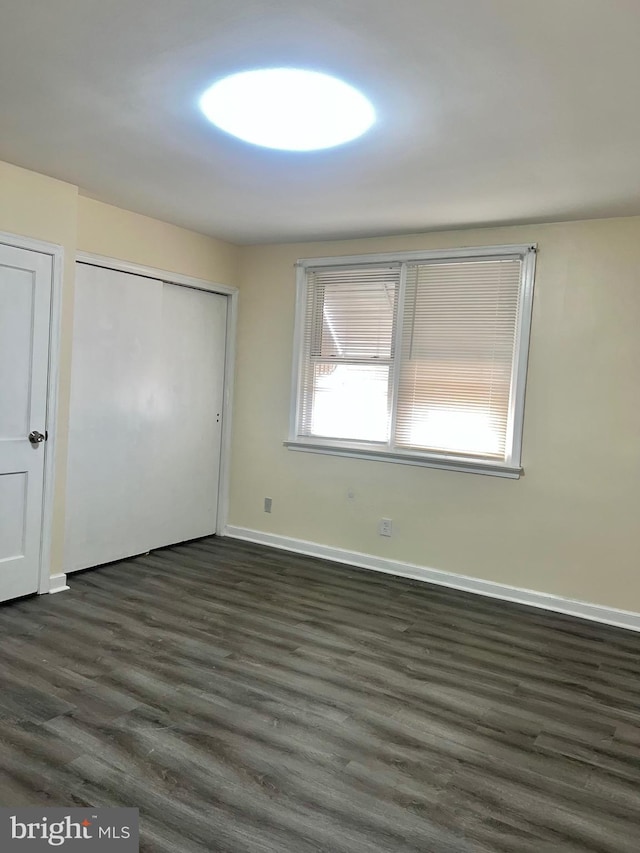 unfurnished bedroom featuring dark hardwood / wood-style flooring