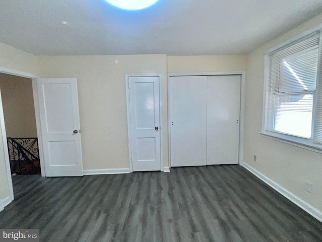 unfurnished bedroom featuring dark wood-type flooring