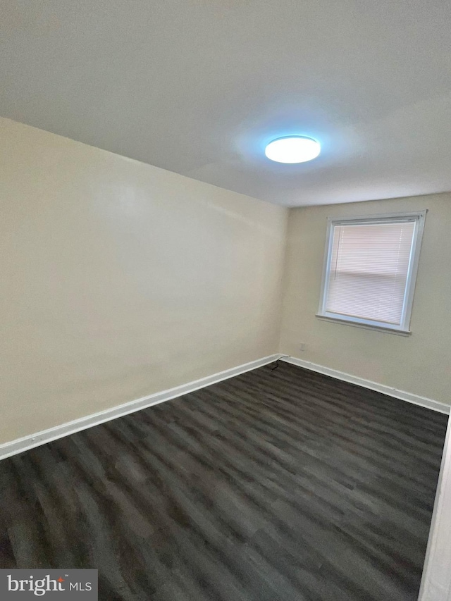 spare room featuring dark hardwood / wood-style floors