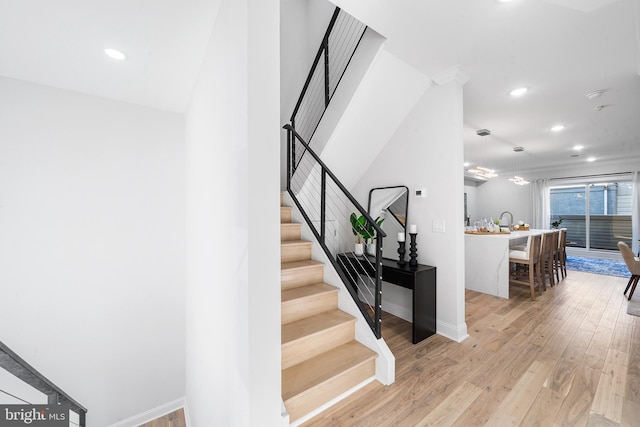 stairway with hardwood / wood-style flooring