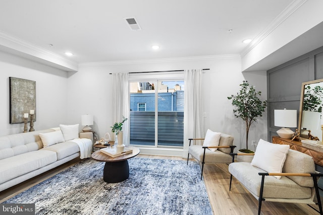 living room with crown molding and wood-type flooring