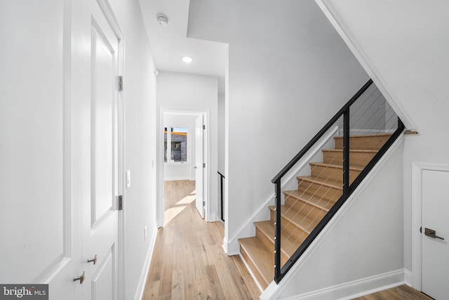 stairs featuring wood-type flooring