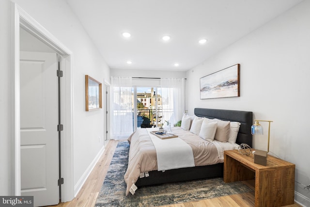 bedroom with access to outside and light wood-type flooring