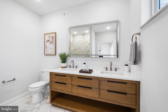 bathroom featuring vanity, toilet, and a shower