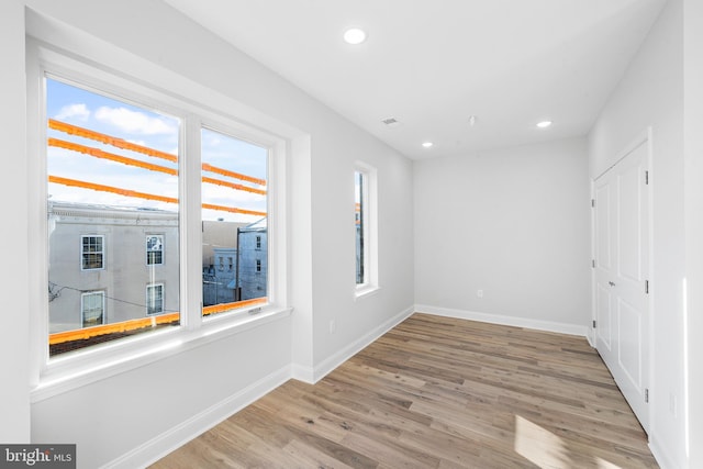 spare room featuring light hardwood / wood-style floors and a wealth of natural light