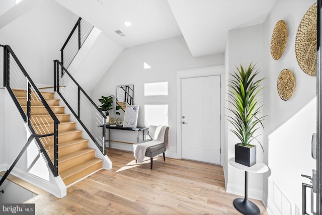 entrance foyer with light wood-type flooring and lofted ceiling