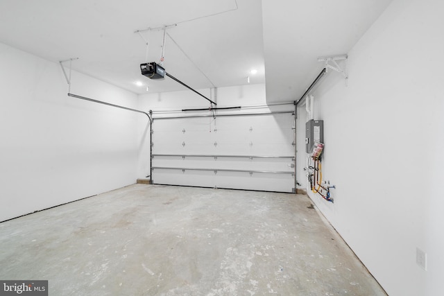 garage featuring electric panel and a garage door opener