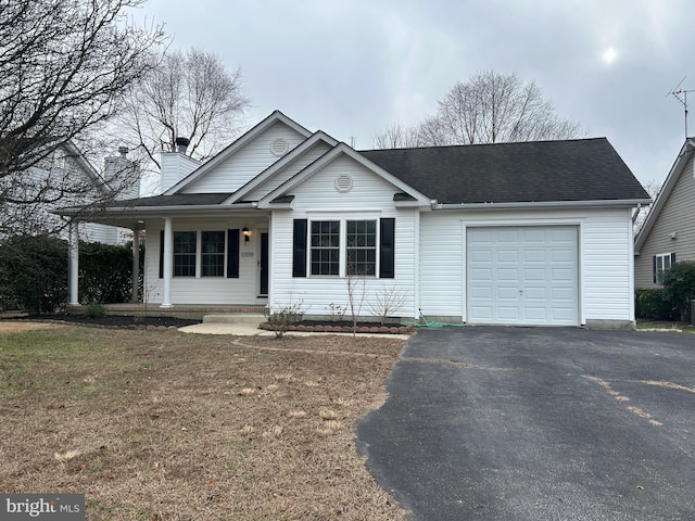 view of front of home featuring a porch and a garage