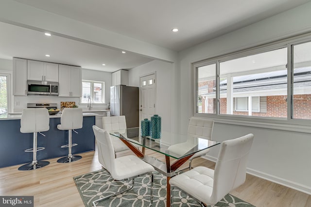 dining space featuring light hardwood / wood-style floors