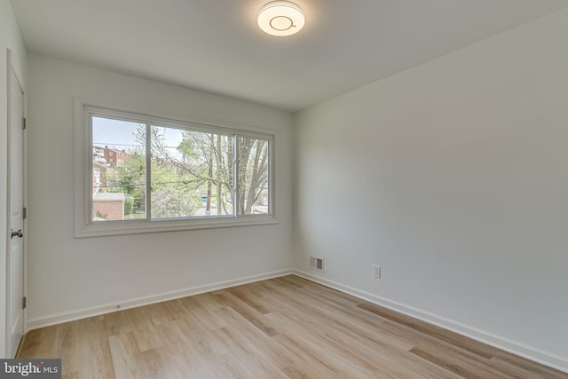 unfurnished room with light hardwood / wood-style flooring