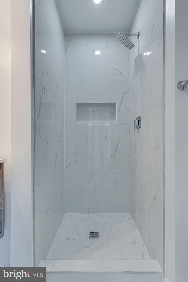 bathroom with tiled shower