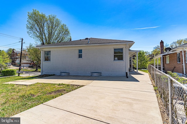 back of property with a lawn and a patio