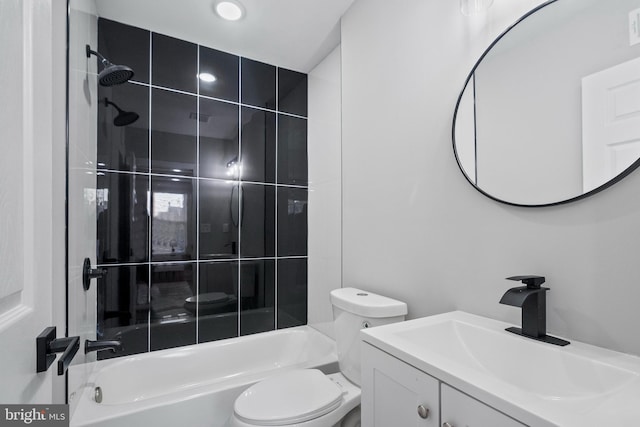 full bathroom featuring vanity, toilet, and tiled shower / bath