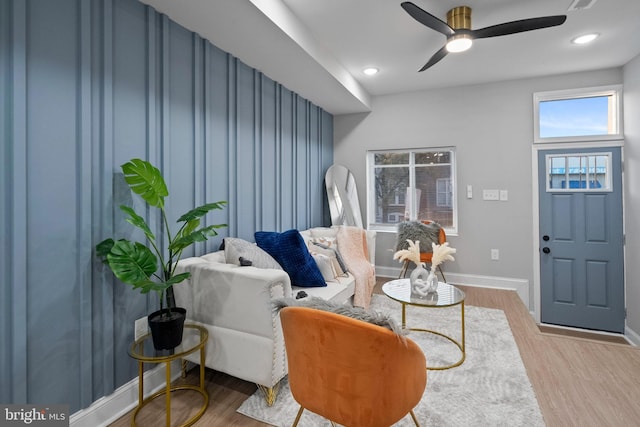 living room with hardwood / wood-style floors and ceiling fan