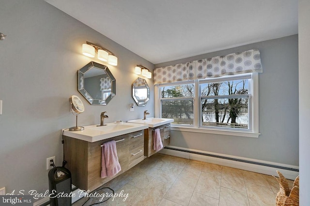 bathroom with tile patterned floors, a baseboard heating unit, and vanity