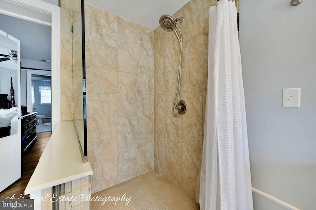 bathroom featuring ceiling fan and a shower with curtain