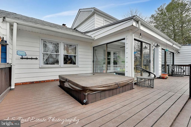 wooden deck featuring a covered hot tub