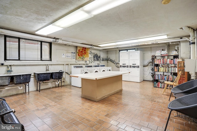 305 C St NE Unit 108, Washington, DC 20002 - interior space featuring stacked washer / dryer, washer and dryer, brick floor, and a textured ceiling