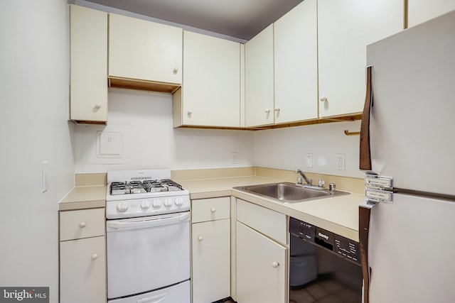 305 C St NE Unit 108, Washington, DC 20002 - kitchen featuring light countertops, a sink, white cabinetry, and white appliances