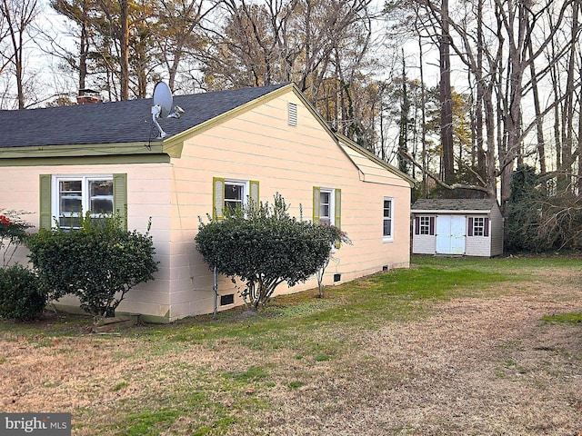view of home's exterior featuring a storage shed and a lawn