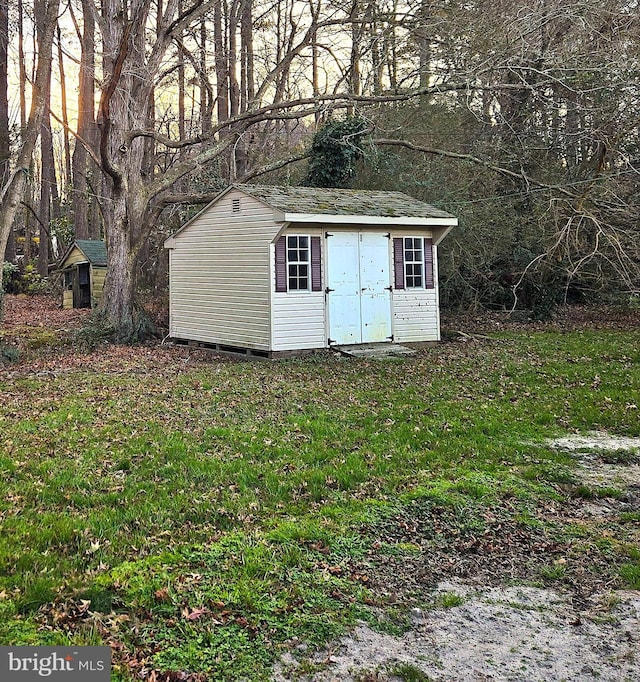 view of outdoor structure featuring a lawn
