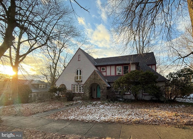 tudor-style house with stone siding