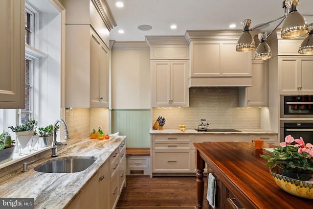 kitchen with decorative backsplash, wood counters, dark wood-style flooring, black electric stovetop, and a sink