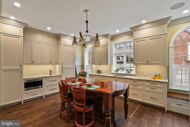 dining space featuring ornamental molding, dark wood finished floors, and recessed lighting