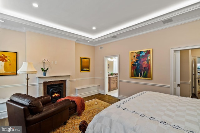 bedroom featuring ornamental molding, wood finished floors, and recessed lighting