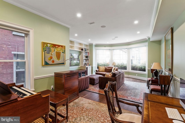 office area with built in features, visible vents, wood finished floors, crown molding, and recessed lighting