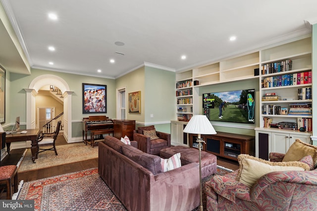 living area featuring dark wood-style floors, arched walkways, crown molding, and recessed lighting