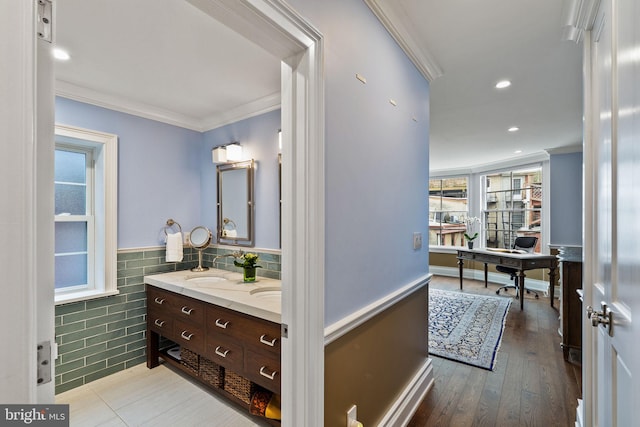 bathroom featuring a wainscoted wall, crown molding, tile walls, recessed lighting, and hardwood / wood-style flooring