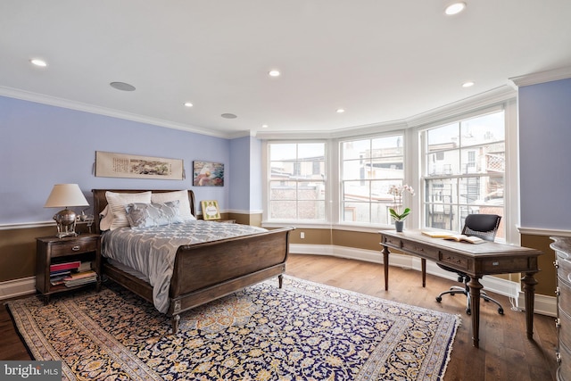 bedroom featuring recessed lighting, wood finished floors, and crown molding